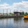 A yellow boat in the river near a dock