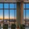 Resident lounge at our apartments for rent in Washington DC, featuring floor to ceiling windows and a long table.